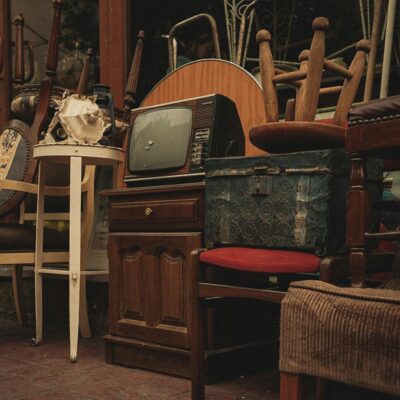 Eclectic mix of vintage furniture and antiques in a store with retro charm.