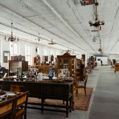 Explore a wide selection of vintage furniture in a spacious antique store interior.