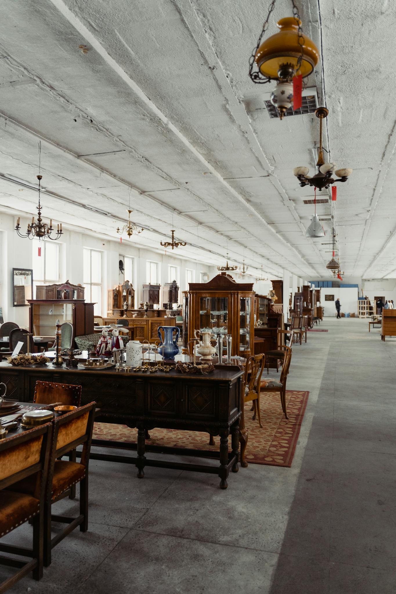 Explore a wide selection of vintage furniture in a spacious antique store interior.